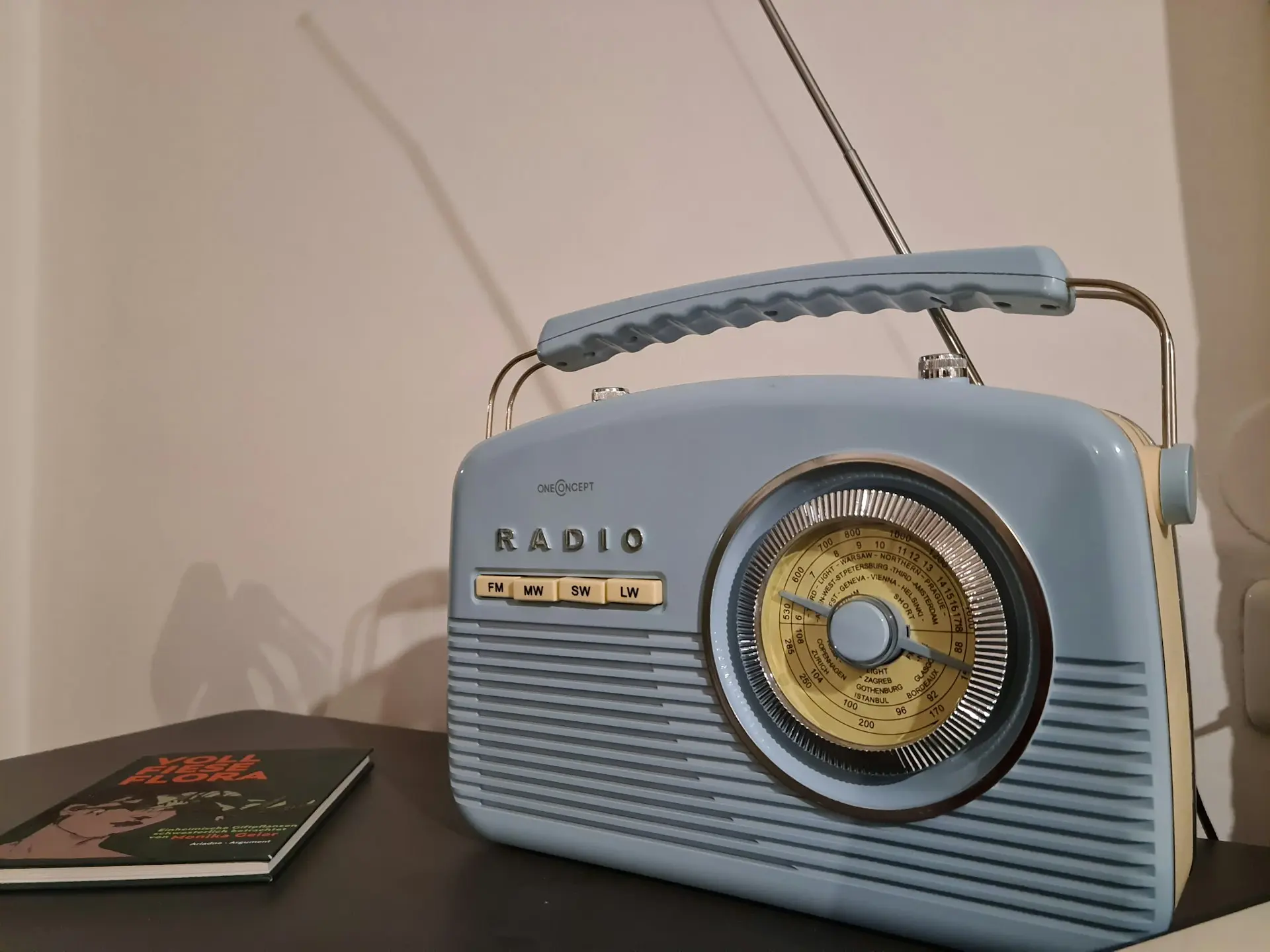 a radio sitting on top of a table next to a book